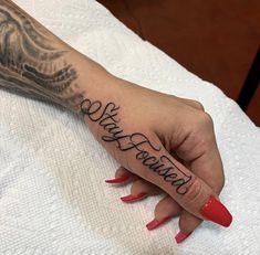 a woman's hand with the word love is forever tattooed on her left arm