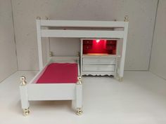 a doll house with a bed and dresser