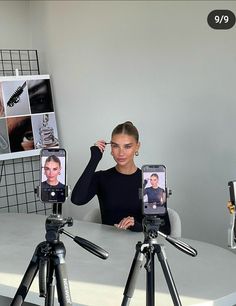 a woman is taking pictures with her cell phone while sitting in front of a tripod