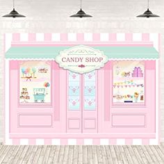 a candy shop with pink and green awnings on the front door is shown