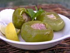 some green peppers are on a white plate