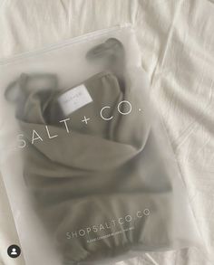 a packaged package with the label salt and co on it sitting on a white sheet