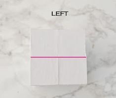 a white box sitting on top of a marble counter next to a pink line that says right