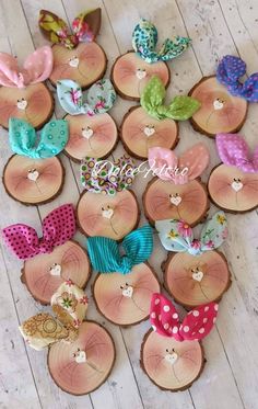 several wooden buttons with bows on them sitting on a table next to other wood pieces