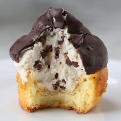 an ice cream filled cupcake with chocolate toppings