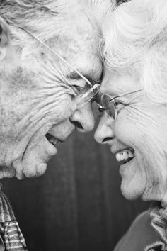 an older couple is smiling and laughing together