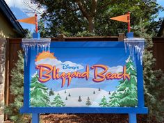 the sign for disneyland's blizzard beach is displayed in front of a wooden fence