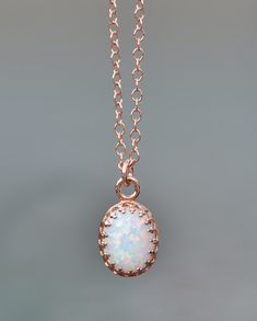 "A sweet new necklace using 14K rose gold and opal. The opal is oval shaped and white in color. It has broad rainbow flashes and excellent fire. Opal is hand set into a premium, rose gold plated crown setting. It hangs from 14K rose gold filled chain, in your length of choice. Opal measures 10mm tall (just under 1/2\") while entire pendant measures 3/8\" long. Please choose desired chain length at checkout. Please see all of my rose gold opal pieces here: https://www.etsy.com/shop/hangingbyathre Elegant Pink Opal Oval Jewelry, Elegant Rose Gold Pink Opal Jewelry, Rose Gold Pink Opal Jewelry Gift, Dainty Rose Gold Opal Jewelry, Delicate Rose Gold Opal Jewelry, Delicate Oval Rose Gold Jewelry, Dainty Oval Rose Gold Jewelry, Dainty Rose Gold Oval Jewelry, Dainty Oval Rose Gold Necklace