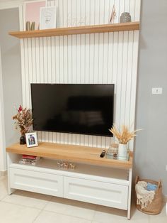 a flat screen tv sitting on top of a white entertainment center