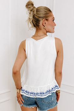 - Go sightseeing in this sweet embroidered top! - Unlined lightweight material with a blue hued floral pattern on the front a - A v-cut neckline with a tie detail and accent tassels - A sleeveless cut - A relaxed silhouette that ends in a ruffle hemline with embroidered detailing Venice Travel, V Cut, V Cuts, Embroidered Top, Venice, Floral Pattern, Tassels, Luxury Fashion, Floral