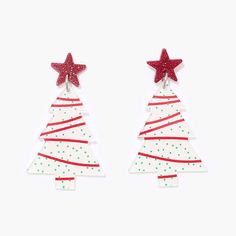 two red and white christmas trees with stars on them