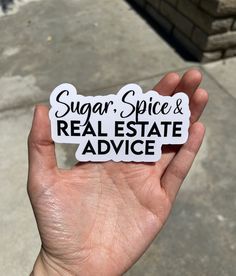 someone holding up a sticker that says sugar spice and real estate advice