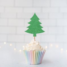 a cupcake with frosting and a green tree on top