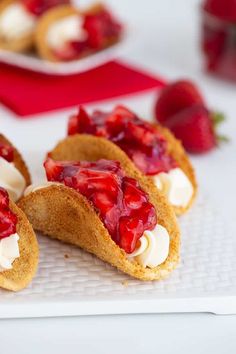 strawberry shortcakes with whipped cream and strawberries on the side, ready to be eaten