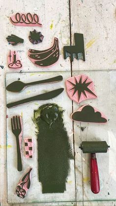 various tools are laid out on top of each other, including paint and paper cutters