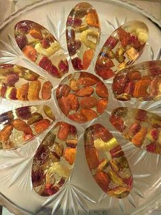 a glass plate topped with sliced fruit and nuts