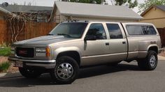 a silver truck parked in front of a house