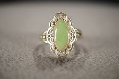 I am offering you this gorgeous vintage sterling silver (stamped) band ring, with a gorgeous marquise shaped genuine intense bezel set green agate stone, set in a fabulous band design ring. This stone has color saturation and intensity that is endless, as seen in the provided pictures. What an eye catcher! has a fancy etched raised relief scrolled etched filigree design setting. This is a very regal design here. This ring is currently a size 7, but could be sized up or down very easily. It weigh Vintage Silver Marquise-shaped Jewelry, Antique Silver Marquise Jewelry, Vintage Marquise Silver Jewelry, Vintage Silver Marquise Jewelry, Vintage Marquise Jewelry Hallmarked, Vintage Marquise Gemstone Jewelry, Vintage Marquise Hallmarked Jewelry, Vintage Hallmarked Marquise Jewelry, Elegant Collectible Turquoise Ring