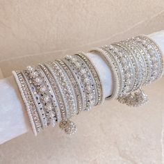 2 Stunning stacks of luxurious silver bangles with with our silver daisy bangles and finished with the prettiest pearl & faux kundan jhumka drop bangle. Perfect for reception brides or those wanting to make a statement. Ready to Ship! White Bangles Set Indian, White Bridal Bangles, Reception Accessories For Bride, Silver And Pearl Jewelry, Silver Bangles Design, Pearls Bangles, White Bangles, Kundan Jhumka, Silver Indian Jewelry