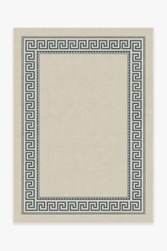 a beige and blue rug with an intricate greek border on the bottom, in front of a white background