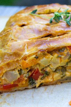 a close up of a vegetable pie on a cutting board