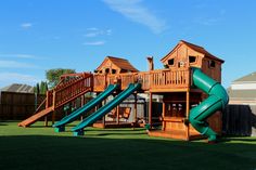 a wooden playset with slide and climbing frame in the back yard on a sunny day