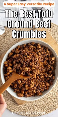 the best tofu ground beef crumbles in a white bowl with a wooden spoon