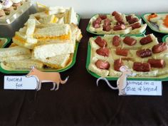 several trays of food on a table at a children's birthday or baby shower