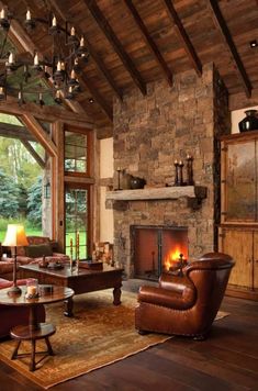 a living room filled with furniture and a fire place in the middle of a room