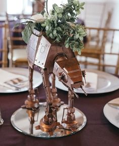 a star wars themed centerpiece with flowers in the shape of a at - at