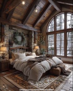 a large bed sitting in a bedroom next to a tall wooden window with lots of windows