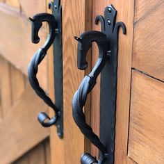 two black iron handles on wooden doors