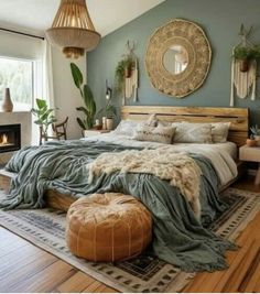 a bedroom with a bed, rugs and pillows on the floor in front of a fireplace