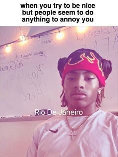 a person with a red bandana on their head standing in front of a whiteboard