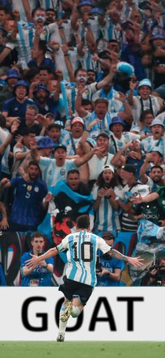 a soccer player is running with the ball in front of a large group of people