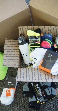 the box is full of items that include socks, water bottle and other sports equipment