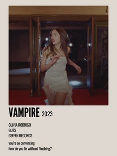 a woman in a short white dress standing next to an open door with the words vampire on it