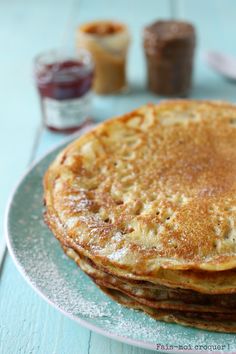 three pancakes stacked on top of each other on a plate with syrup in the background