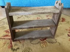 a wooden shelf sitting on top of a rug