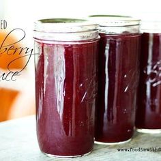 three jars filled with liquid sitting on top of a table