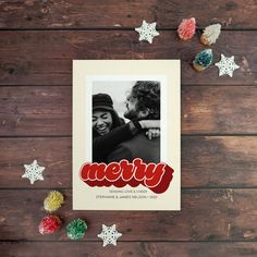 a christmas card with the word merry written in red on it next to confetti sprinkles