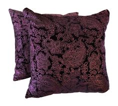 two purple decorative pillows on a white background