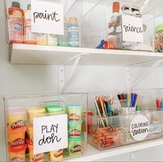 the shelves are filled with different types of paint and art supplies for kids to use