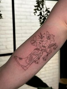 a woman's arm with flowers on it