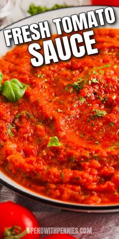 fresh tomato sauce in a white bowl with basil on top and tomatoes around the edges