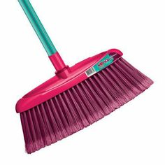 a pink broom with green bristles on it