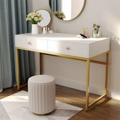 a white desk with gold legs and a mirror