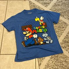 New Without Tags. Smoke Free Home. Boys Size Small. Bright Blue Color With Super Mario Design. Short Sleeves. Super Mario Tshirt, Super Mario Design, Mario Tshirt, Mario Design, Super Mario Shirt, Mario Shirt, Bright Blue Color, Super Mario Birthday, Mario Birthday