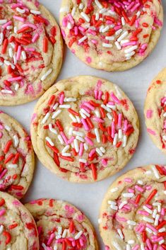 several cookies with sprinkles and red, white, and pink frosting