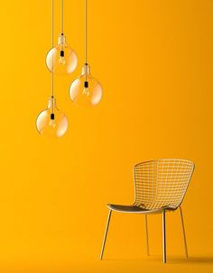 an image of a chair and some lights hanging from it's sides on a yellow background